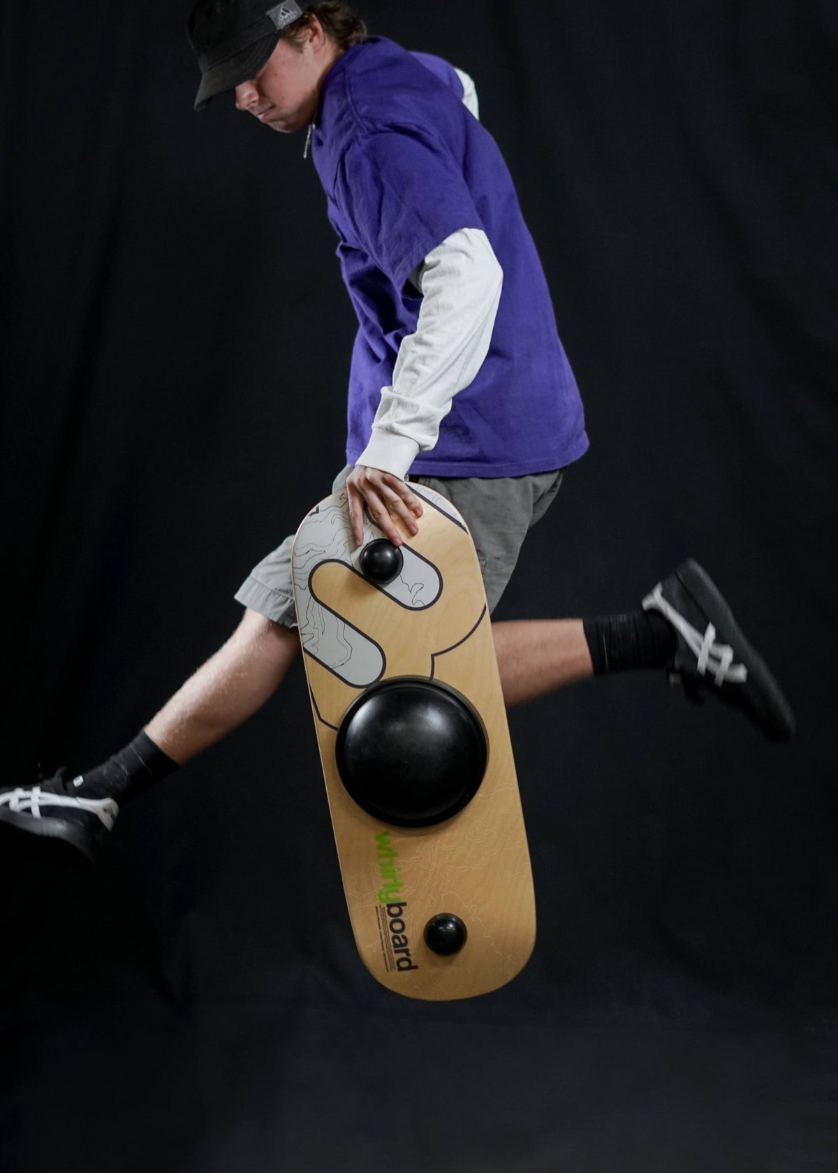 Man jumping with a Whirly Desk Rider in a studio