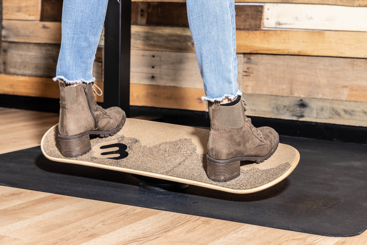 Boots on a cork Whirly Sport 360 on a standing desk mat