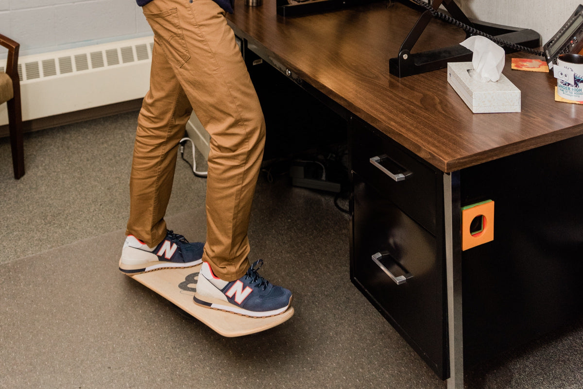 Feet on a Whirly Board beside a standing desk