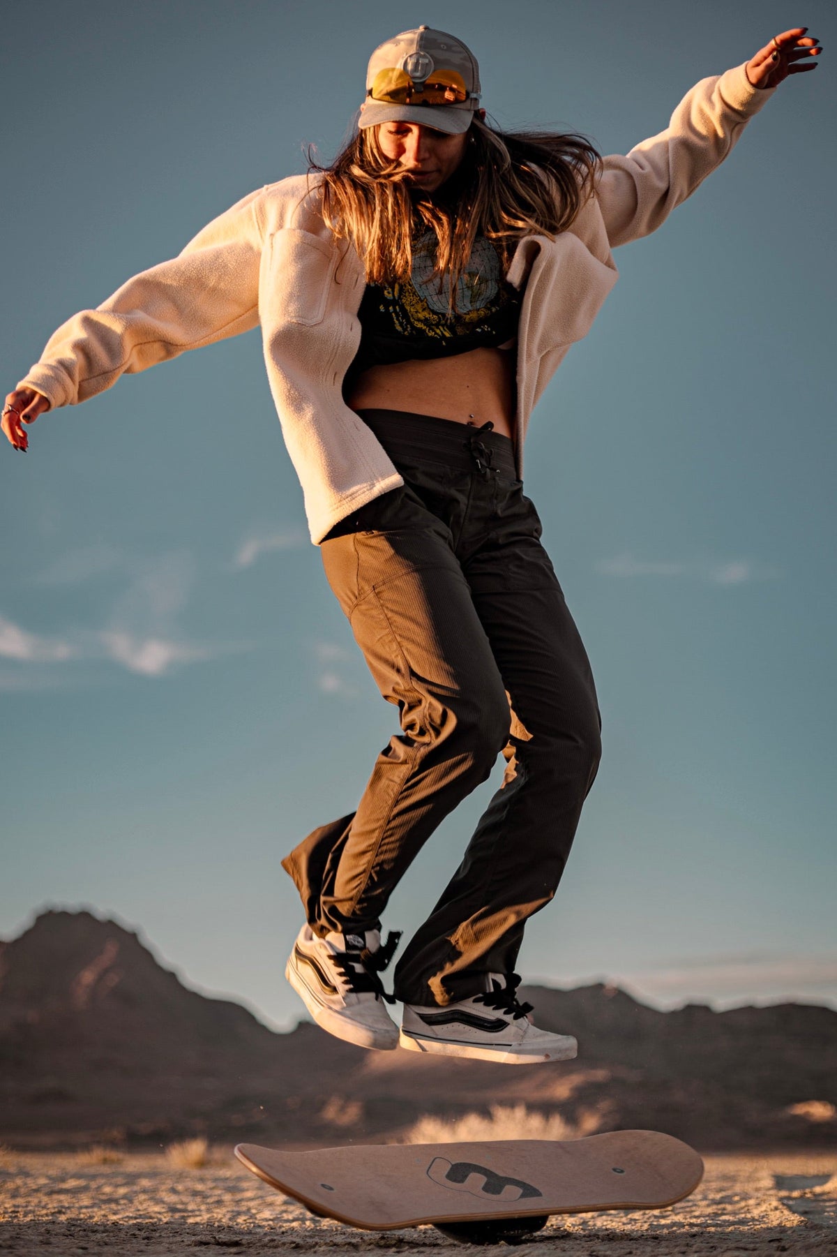 Woman balancing on a Whirly Board on the salt flats at golden hour