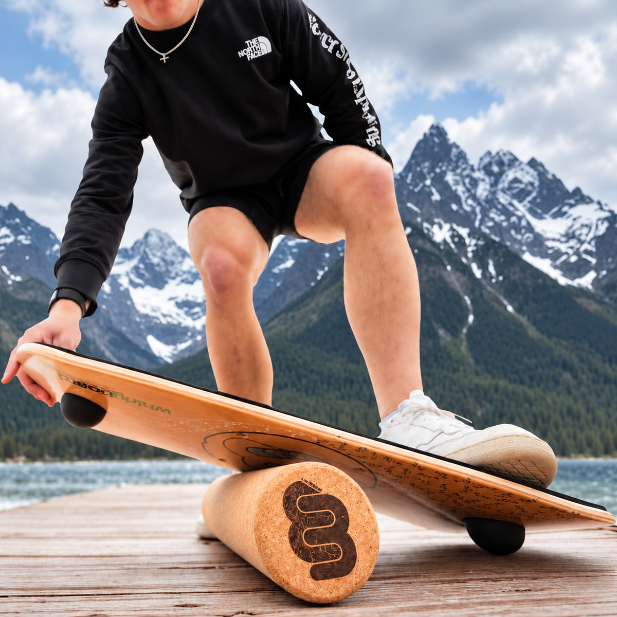 Cork Roller supporting a Whirly Complete board during a balance session on a lakeside dock
