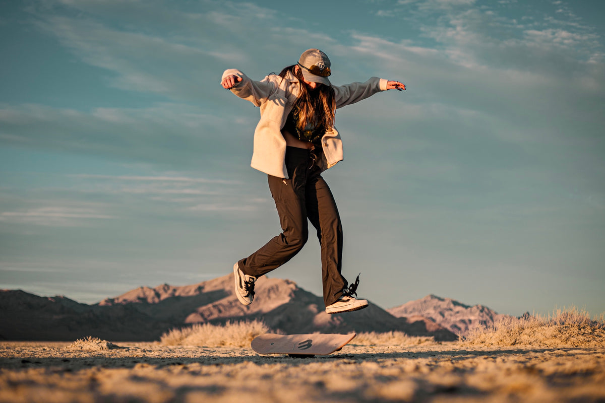 A rider jumping above her Whirly Board on the Utah salt flats