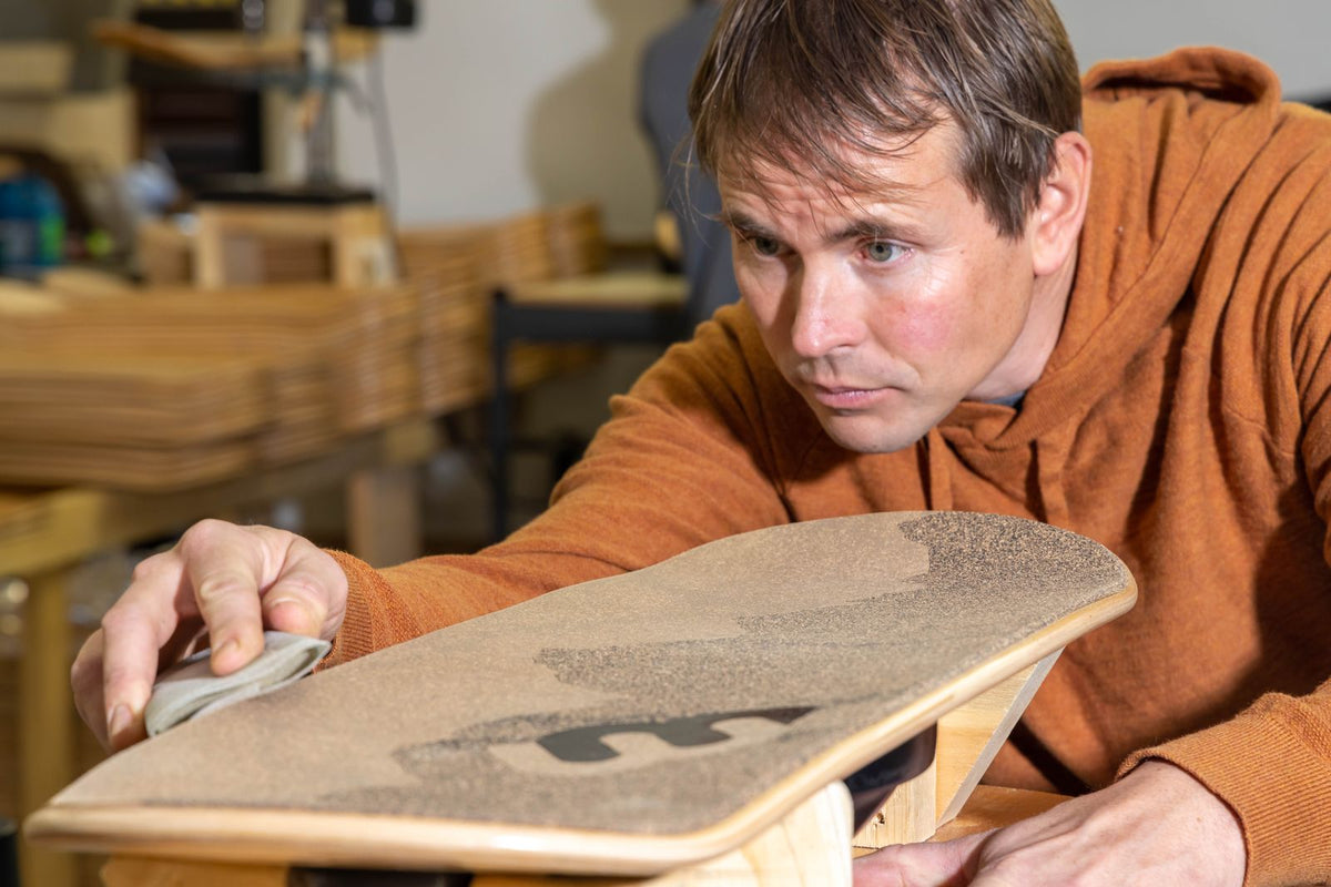 Erik trimming grip tape by hand