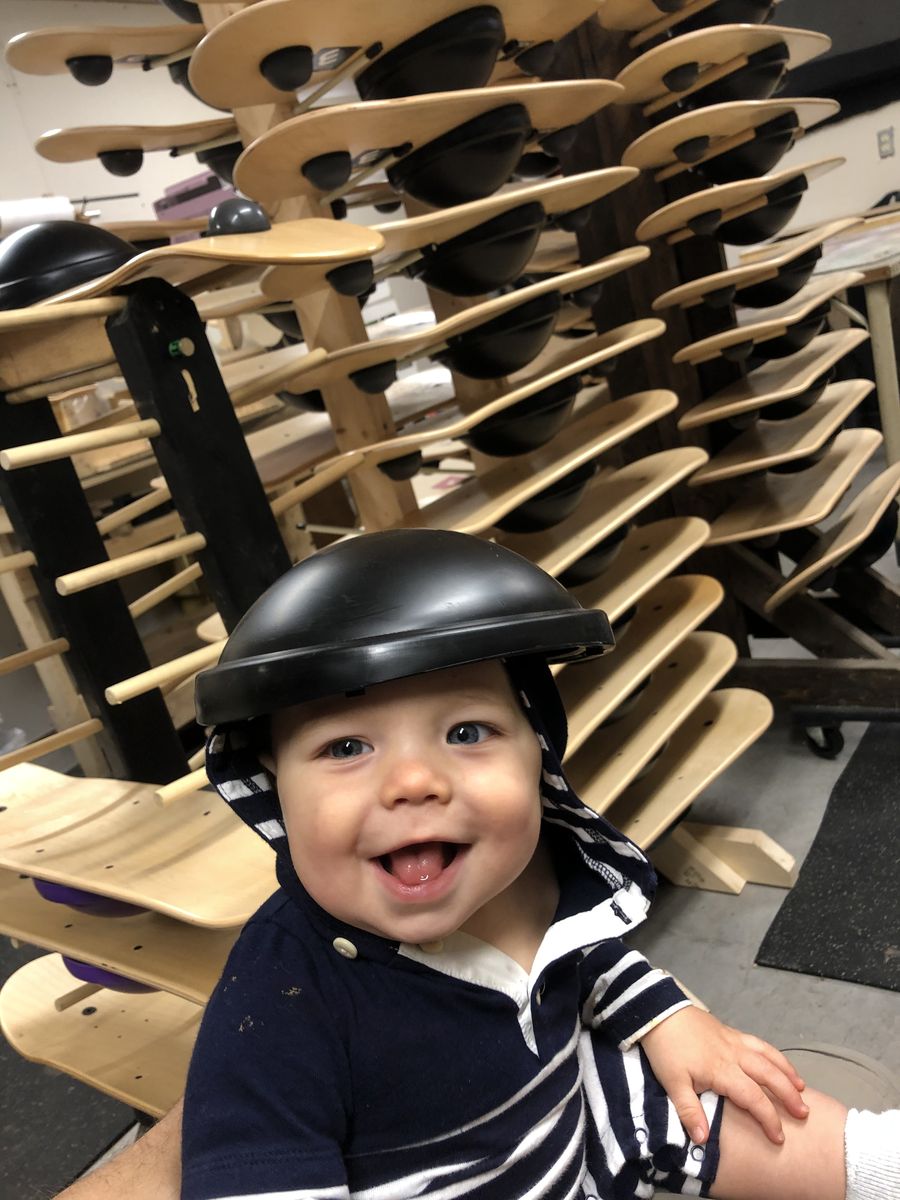 Paxton in a helmet in the workshop