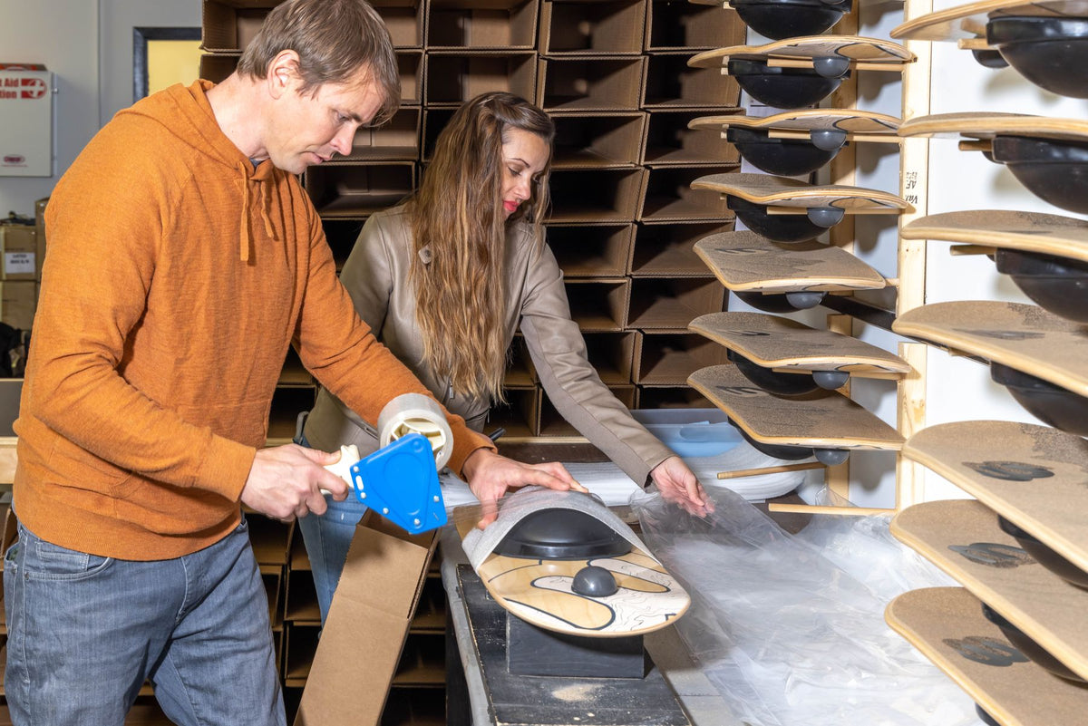 Erik and Joanna packing Whirly Boards in the workshop