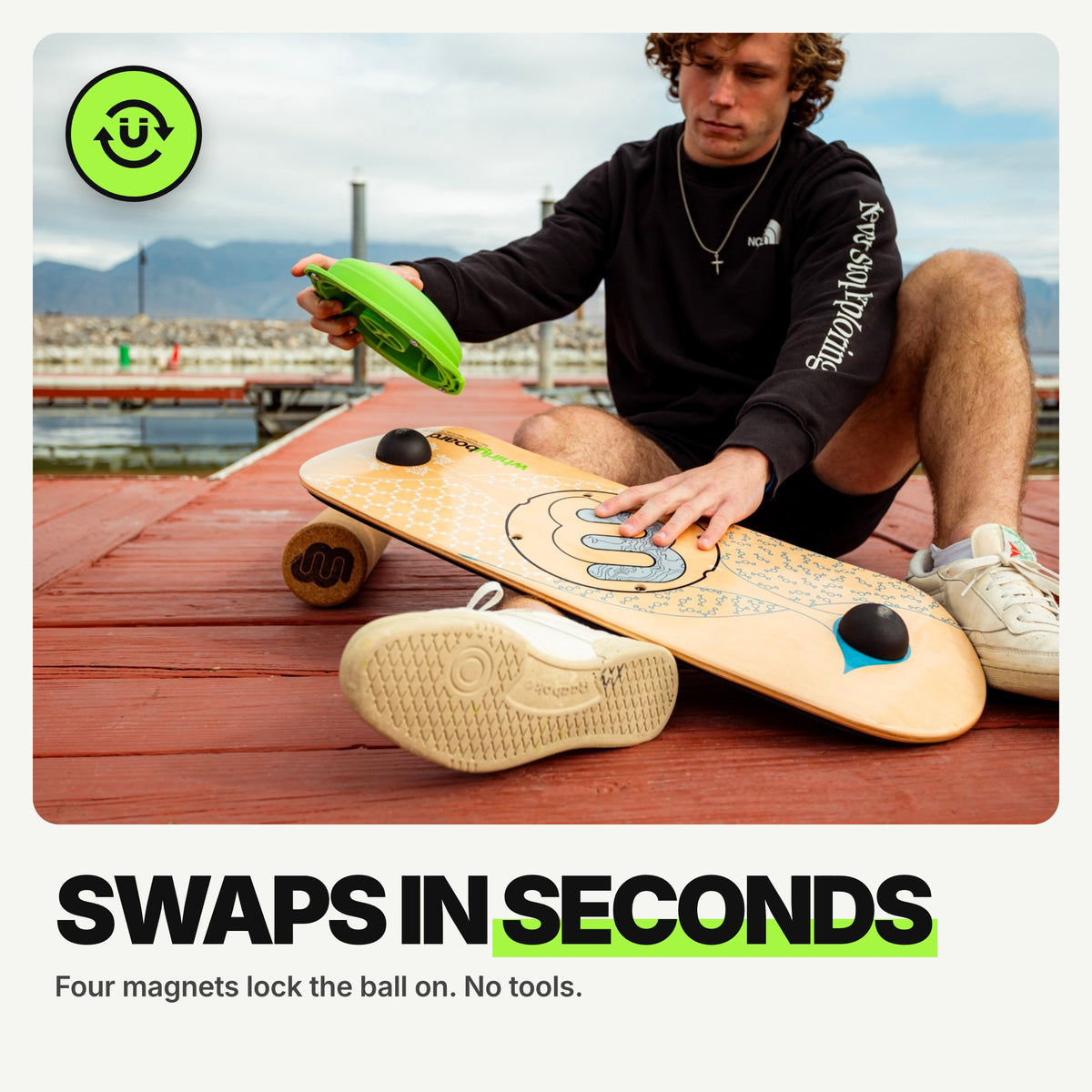 Swaps in seconds: rider lifting the green MagLock ball off the Whirly Complete deck on a dock