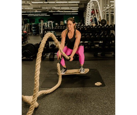 woman doing sports performance training on a whirly board