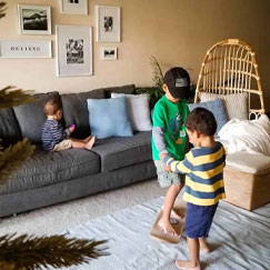 little kids playing on whirly board indoors